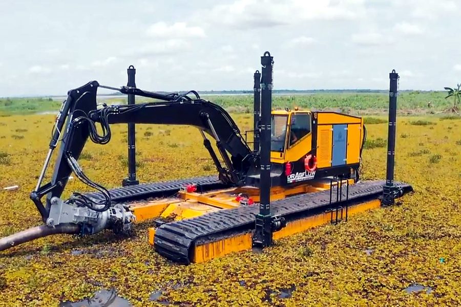 Dragflow amphibious excavator dredging an overgrown wetland